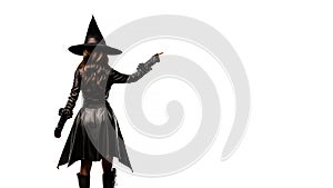 Halloween witch looking back, pointing finger to empty space. Generative AI