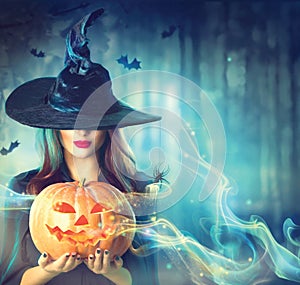 Halloween witch with a magic pumpkin