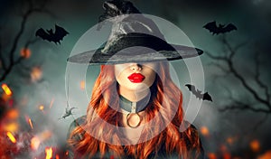 Halloween. witch portrait. Beautiful woman in witches hat with long curly red hair
