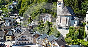 HALLSTATT, AUSTRIA - SEPTEMBER 3, 2021: Aerial view of the beautiful town from a flying drone over the lake in summer season