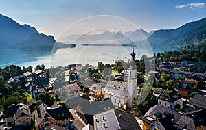 Hallstatt, Austria. View to Hallstattersee Lake and Alps mountains summits. Ancient houses at lake banks with chapel