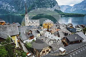 Hallstatt buildings roofs and Lutheran Church with lake and mountins in backgroudn. Salzkammergut region, Austria, Alps