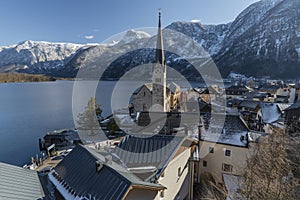 Hallstatt old town in winter blue day with church with tower in Austria