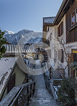 Hallstatt old town in winter blue day with church with tower in Austria