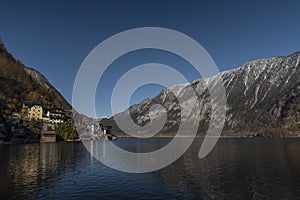 Hallstatt old town in winter blue day with church with tower in Austria