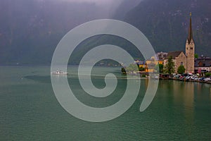 Hallstatter lake and Hallstatt village with cloudy sky in Austrian Alps.