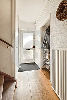 a hallway with a door to a closet and stairs
