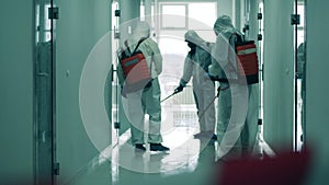Hallway is getting cleaned with chemicals by inspectors. Coronavirus, covid-19 concept.