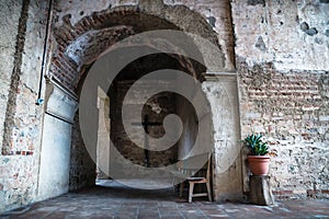 Hallway of Hermano Pedro monestery with cross, plant and arch, Antigua, Guatemala photo