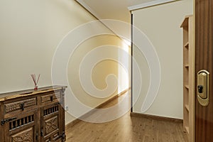 Hallway of a home with a Castilian-type wooden furniture and access to a hallway in an urban residential house with wooden floors