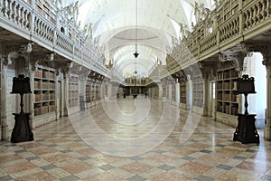 a hallway inside a very large building with lots of bookshelves