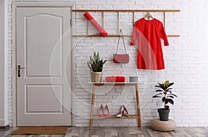 Hallway interior with furniture, shoes and plants