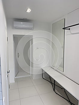 Hallway with a mirror at home in white style