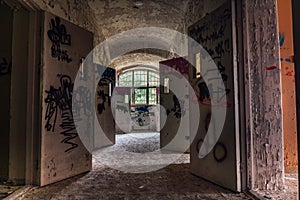 Hallway with open doors from an abandoned mental institution