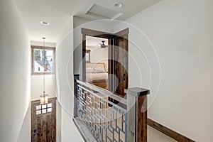 Hallway with staircase and open door to bedroom