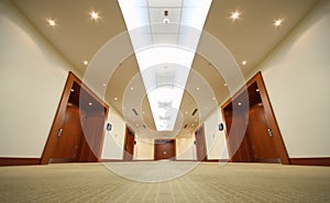 Hallway with wood doors, door at end of corridor