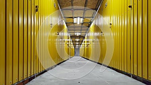 Hallway with yellow storage units. Concrete floor. photo