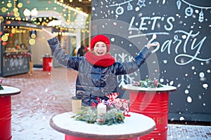 Hally european teenage girl laugh and drop snowflakes in air. Model is on christmas fair. Happy holidays
