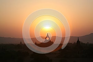 A halo of Burma sunset over Bagan pagodas