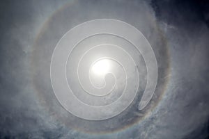 The halo is a circle around the sun as a rare natural phenomenon in the sky.