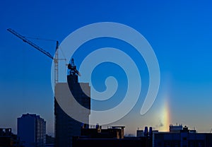 Halo over the city in the frosty winter morning