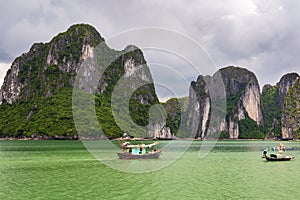 Halong Bay limestone cliffs with two traditional fishing boats, UNESCO world natural heritage, Vietnam