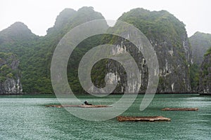 Halong Bay in mystical clouds. Mystical atmoshpere in the world famous halong bay.