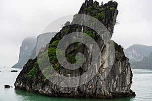 Halong Bay in mystical clouds. Mystical atmoshpere in the world famous halong bay.