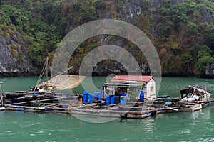 Halong Bay in mystical clouds. Traditional fishermens village in ther sea. Mystical atmoshpere in the world famous halong bay. t