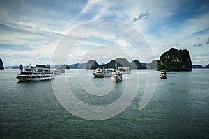 Halong bay with tourist junks and rocky islands. Popular landmark, famous destination of Vietnam