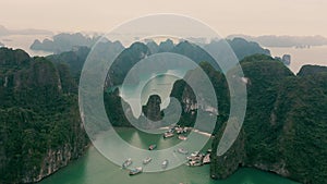 HALONG BAY, VIETNAM - APRIL, 2020: Aerial panorama view of the pier in the rocky islands of Halong Bay in Vietnam.