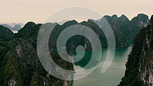 HALONG BAY, VIETNAM - APRIL, 2020: Aerial panorama view of stone islands with rainforests of Halong Bay in Vietnam.