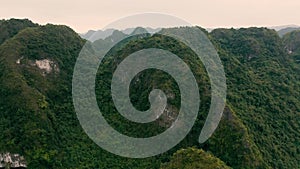 HALONG BAY, VIETNAM - APRIL, 2020: Aerial panorama view of stone islands with rainforests of Halong Bay in Vietnam.