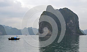 Halong Bay - Vietnam - Large Karsts and small traditional fishing boat