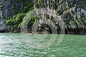 Halong bay in Vietnam, UNESCO World Heritage Site, with paddling kayak.