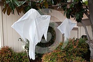 Haloween front door decoration - white sheet ghosts on trees and white sceleton