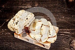 Halumi cheese on a wooden background. Preparation of cheese Halumi. Cheese Halumi with mint