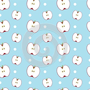 Halve red apples with dots on blue background.