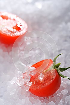Halved cherry tomato on sea rock salt