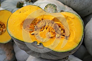 Halved lumina pumpkin with grey skin and orange fruit flesh, decorative autumn vegetable for halloween and thanksgiving, selected photo