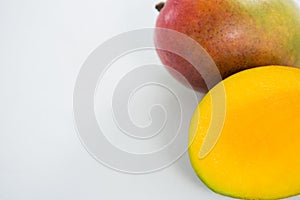Halved mango on white background