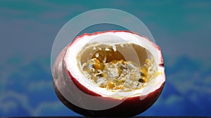 Close up of fresh passion fruit, bursting with sky-blue background. Comestible. photo