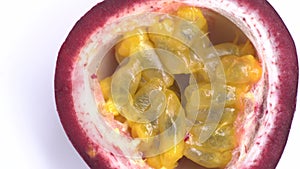 Halved Passion Fruit spin on white background. Close up footage of exotic fruit