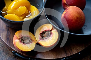 Halved peach with sliced and whole ones