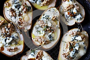 Halved Pears in a pan baked with Dorblu cheese, honey, walnuts and thyme.