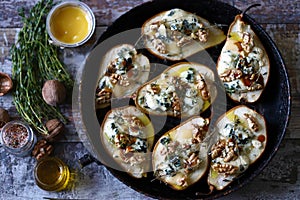 Halved Pears in a pan baked with Dorblu cheese, honey, walnuts and thyme.