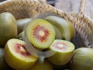 Halved red kiwis in a basquet