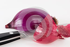 Halved red onion with a kitchen knife