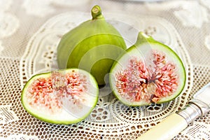 Halved, ripe figs close up in a vintage kitchen setting