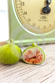 Halved, ripe figs in vintage/retro kitchen setting